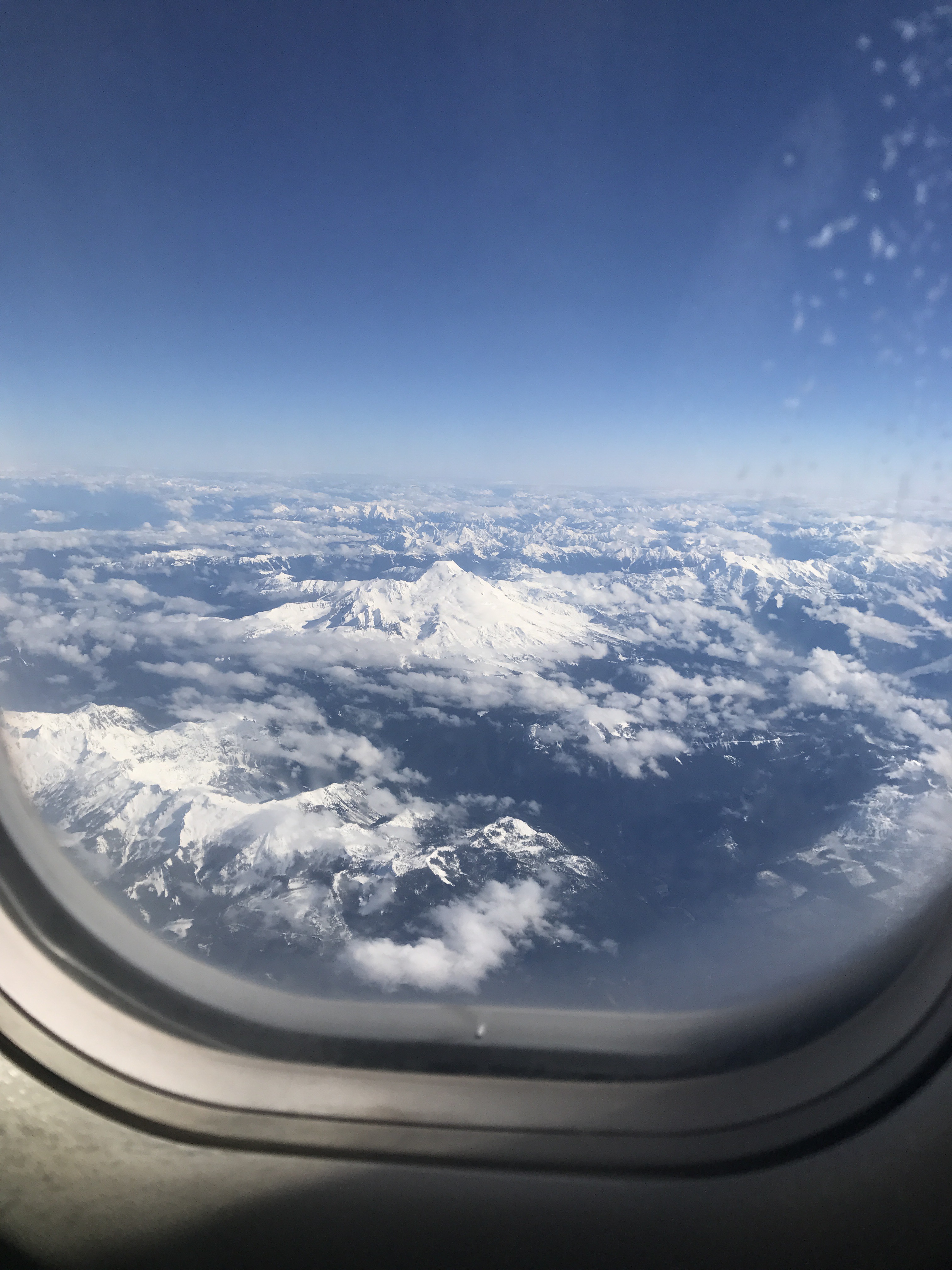 picture out the window of an airplane showcasing the white peak of a mountain near Vancouver, British Columbia.