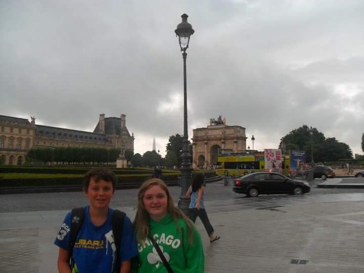 Bri adn her cousin Patrick posing in front of the arc de triomphe in Paris, France.