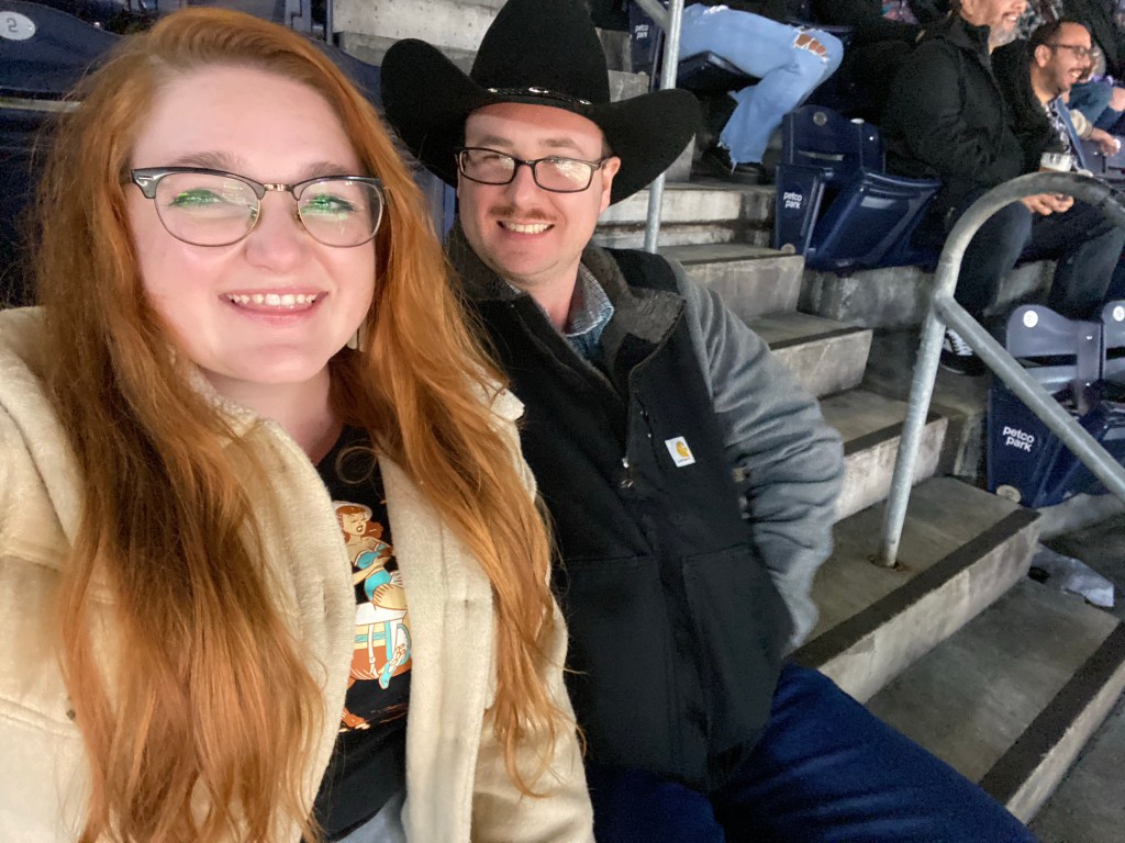 A selfie of Bri and Tyler smiling at the rodeo.